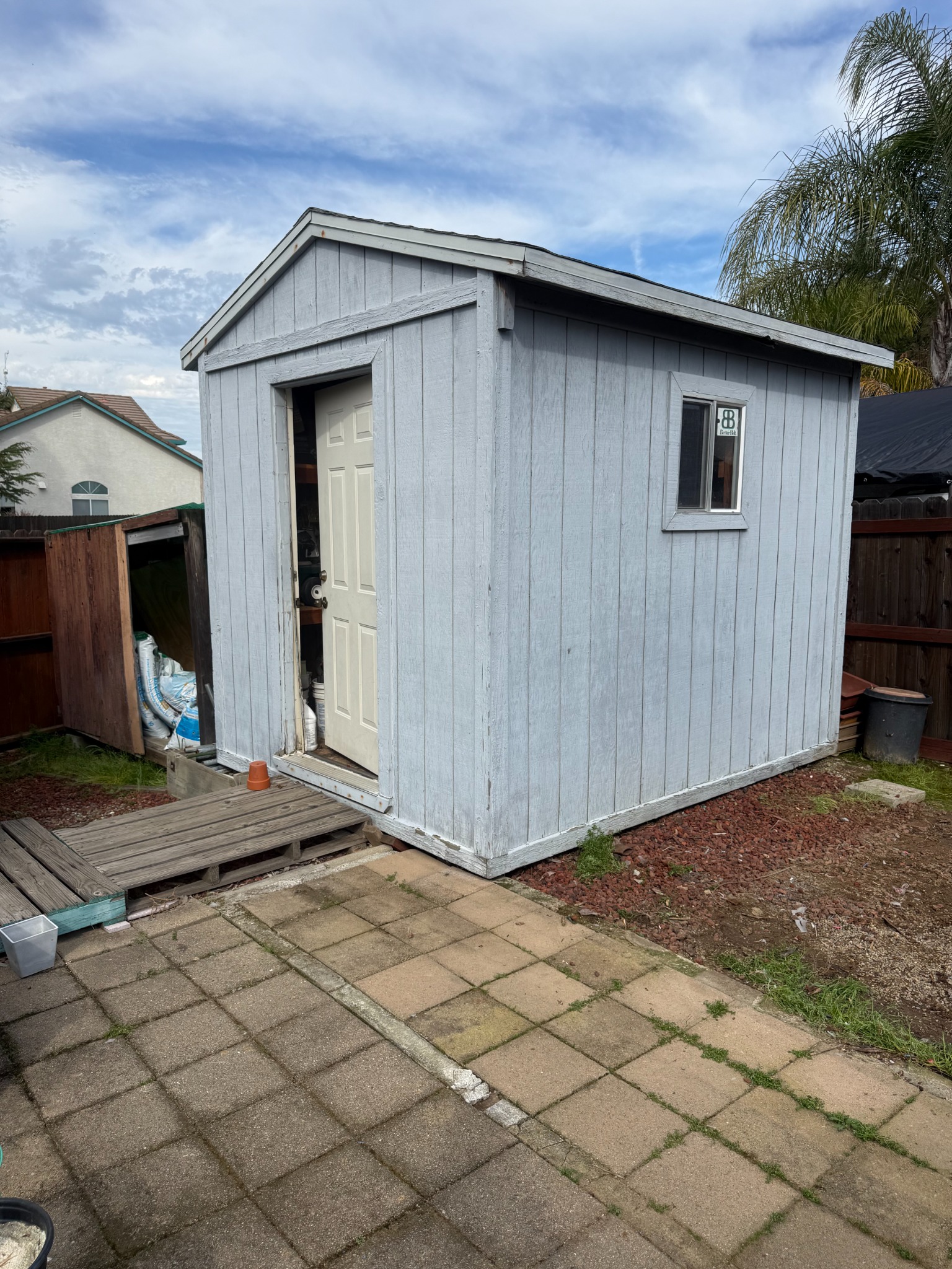 Before shed demolition in Elk Grove showing backyard shed before removal
